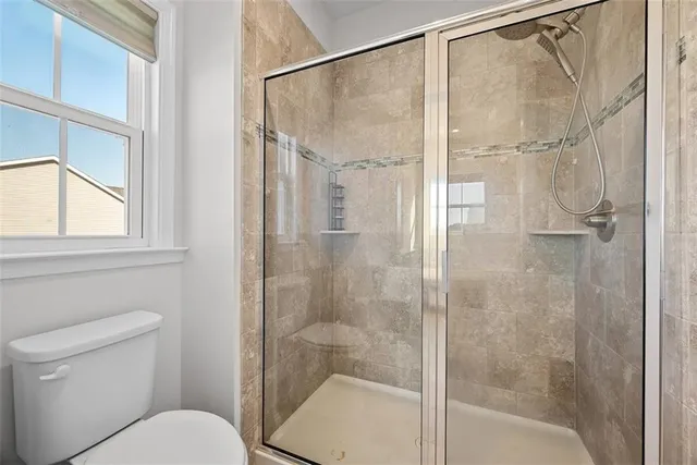 a bathroom with a shower and toilet