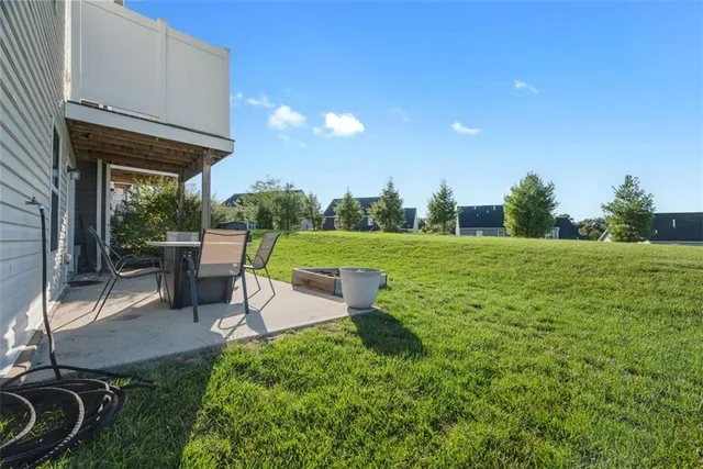a view of a backyard with sitting area