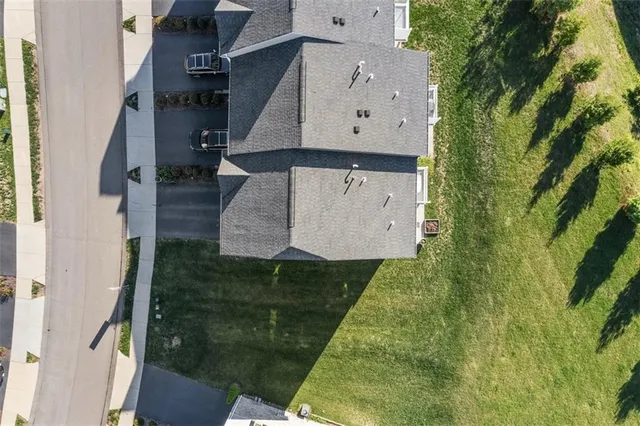 an aerial view of residential house with pool and yard