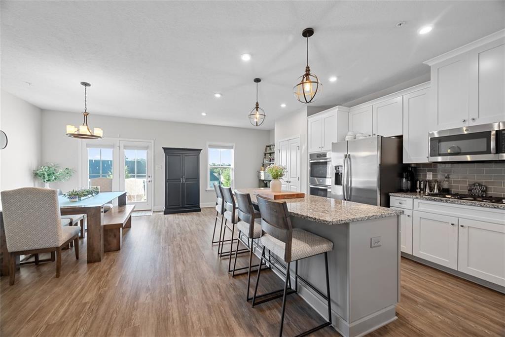 131 Cole Drive McKees Rocks, PA 15136 - Photo 6 of 42 a kitchen with stainless steel appliances a dining table chairs stove refrigerator and cabinets
