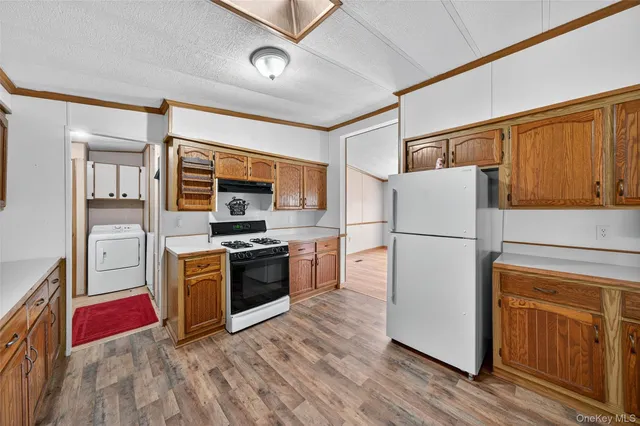 a front view of house with yard and trees in the background