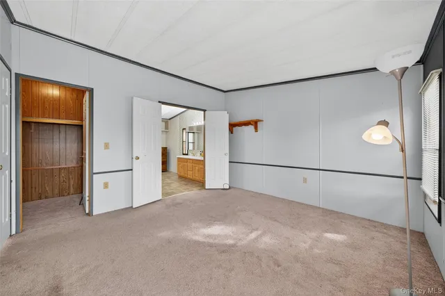 a bed room with a bed and three large window