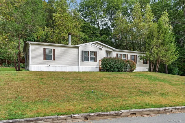 wooden floor fireplace and windows in an empty room