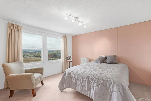 a bedroom with a large bed and a large window