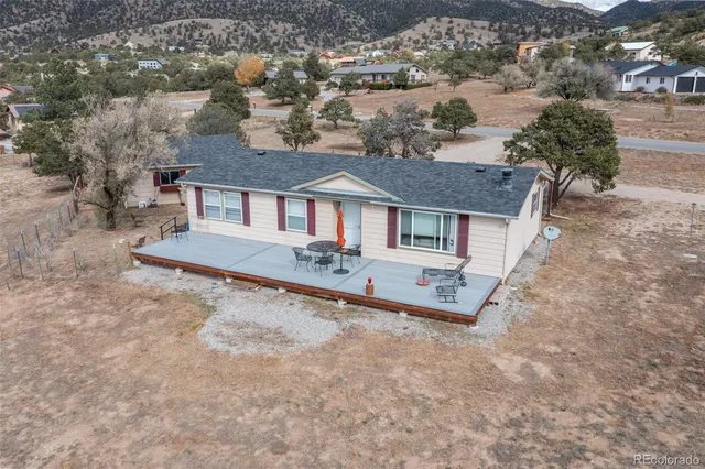 an aerial view of a house with a yard and garage