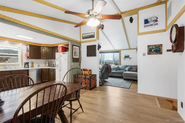 a living room with furniture and a view of kitchen