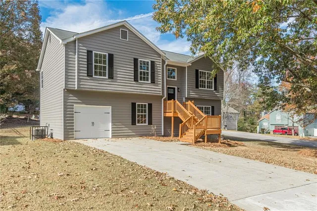 a view of a house with wooden fence