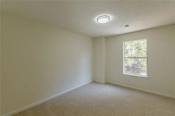 a view of a livingroom with a ceiling fan and entryway