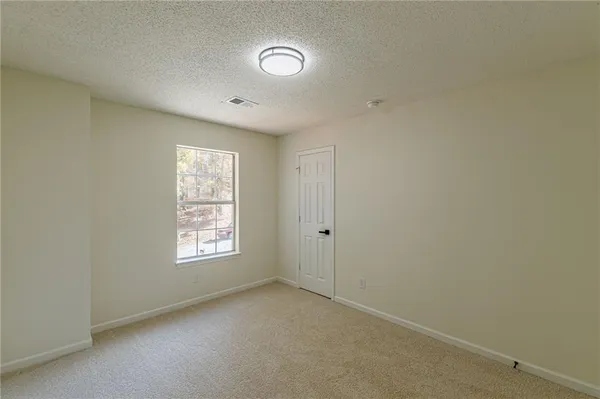 a view of an empty room and a window