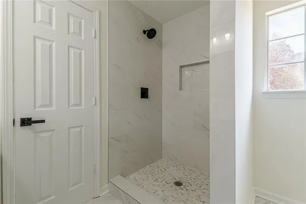 an empty room with fireplace and fan