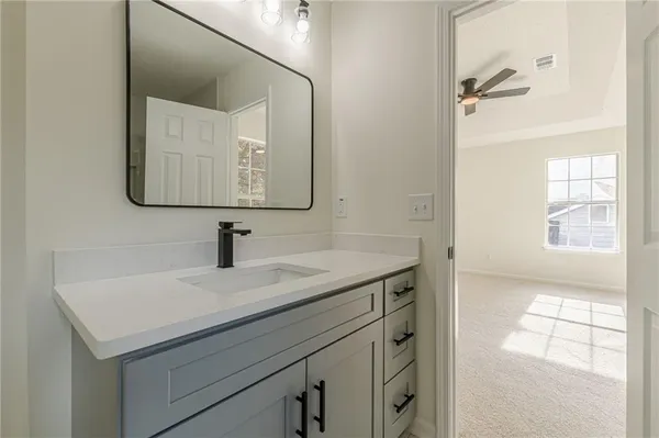 an empty room with windows and ceiling fan view