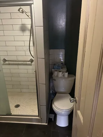 a bathroom with a sink shower and a mirror