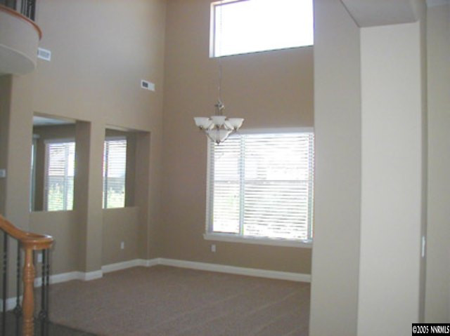 645 Equine Court Reno, NV 89521 - Photo 5 of 9 a view of an empty room with wooden floor and a window