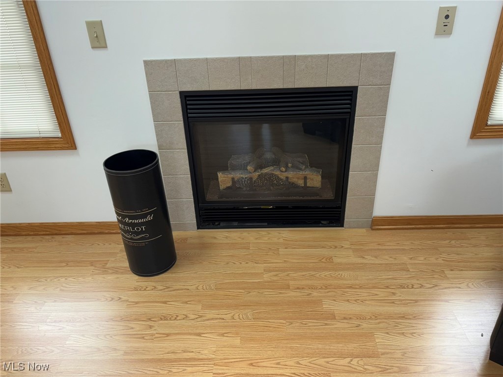 9260 Fowl Road Elyria, OH 44035 - Photo 4 of 25 Room details featuring wood-style floors and a tiled fireplace