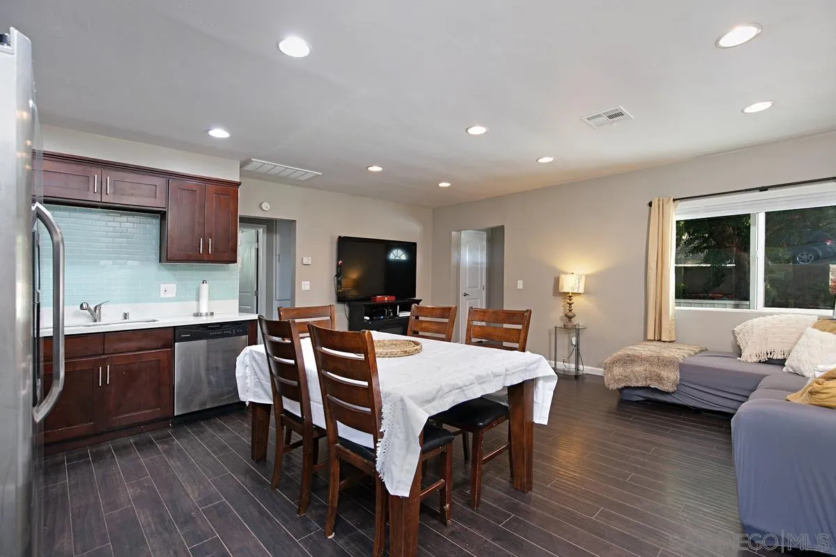 10390 Del Rio Road Spring Valley, CA 91978 - Photo 11 of 38 a kitchen with stainless steel appliances granite countertop a sink table and chairs