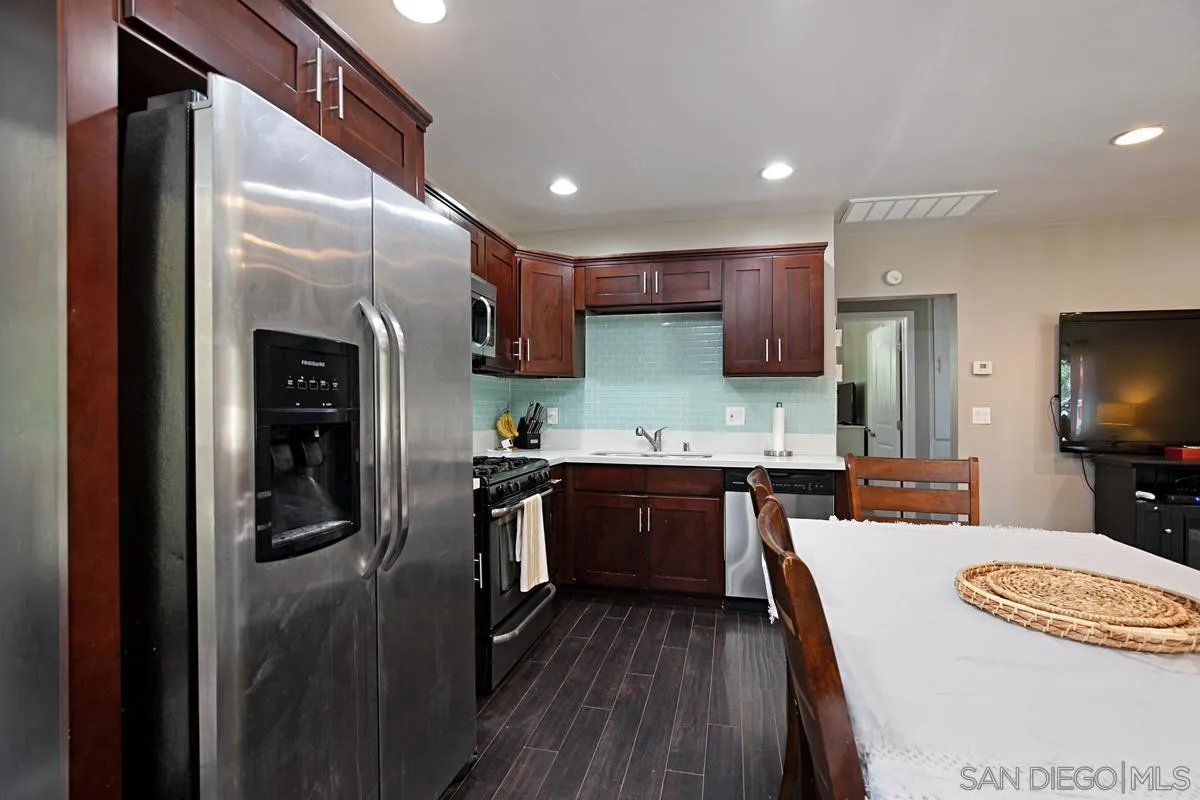 10390 Del Rio Road Spring Valley, CA 91978 - Photo 12 of 38 a kitchen with stainless steel appliances granite countertop a refrigerator a sink a stove and oven