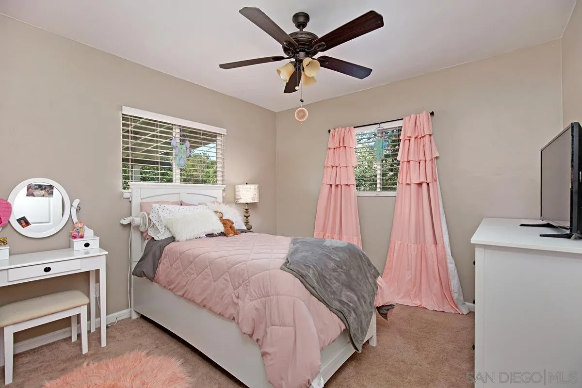 10390 Del Rio Road Spring Valley, CA 91978 - Photo 13 of 38 a bedroom with a bed and a flat screen tv