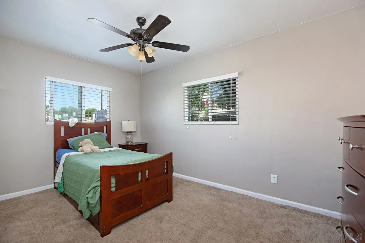 10390 Del Rio Road Spring Valley, CA 91978 - Photo 16 of 38 a bedroom with a bed and window