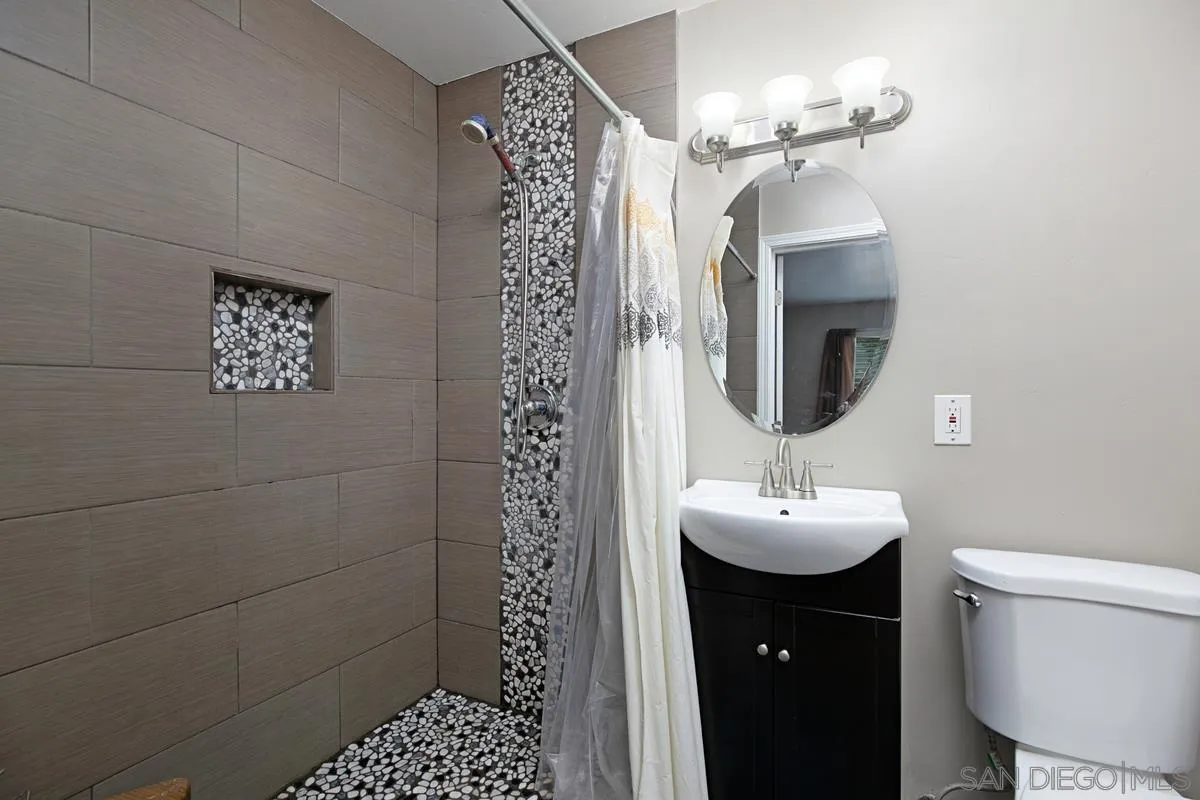 10390 Del Rio Road Spring Valley, CA 91978 - Photo 19 of 38 a bathroom with a sink a toilet and shower