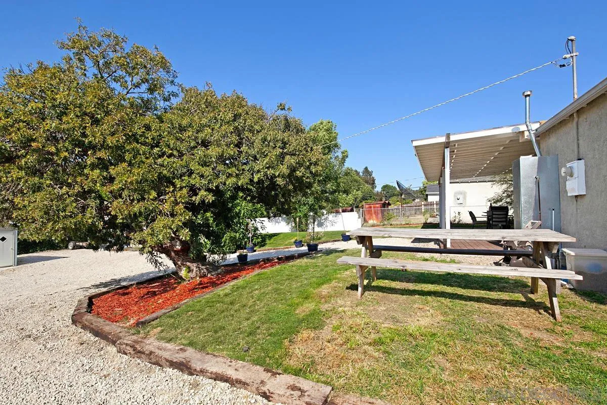 10390 Del Rio Road Spring Valley, CA 91978 - Photo 27 of 38 a view of a swimming pool with a bench and some trees