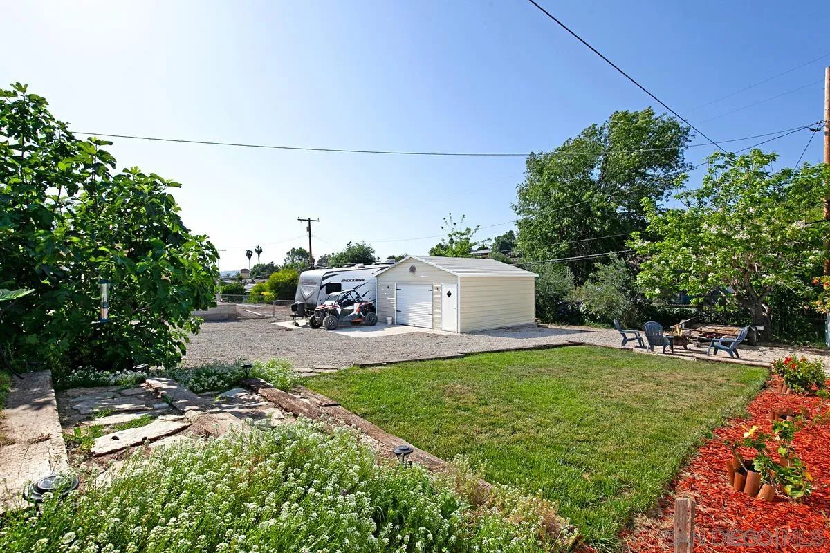 10390 Del Rio Road Spring Valley, CA 91978 - Photo 30 of 38 a front view of a house with a yard and garage