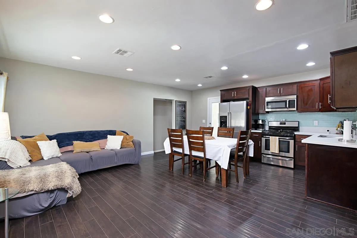 10390 Del Rio Road Spring Valley, CA 91978 - Photo 4 of 38 a living room with stainless steel appliances furniture wooden floor and a kitchen view