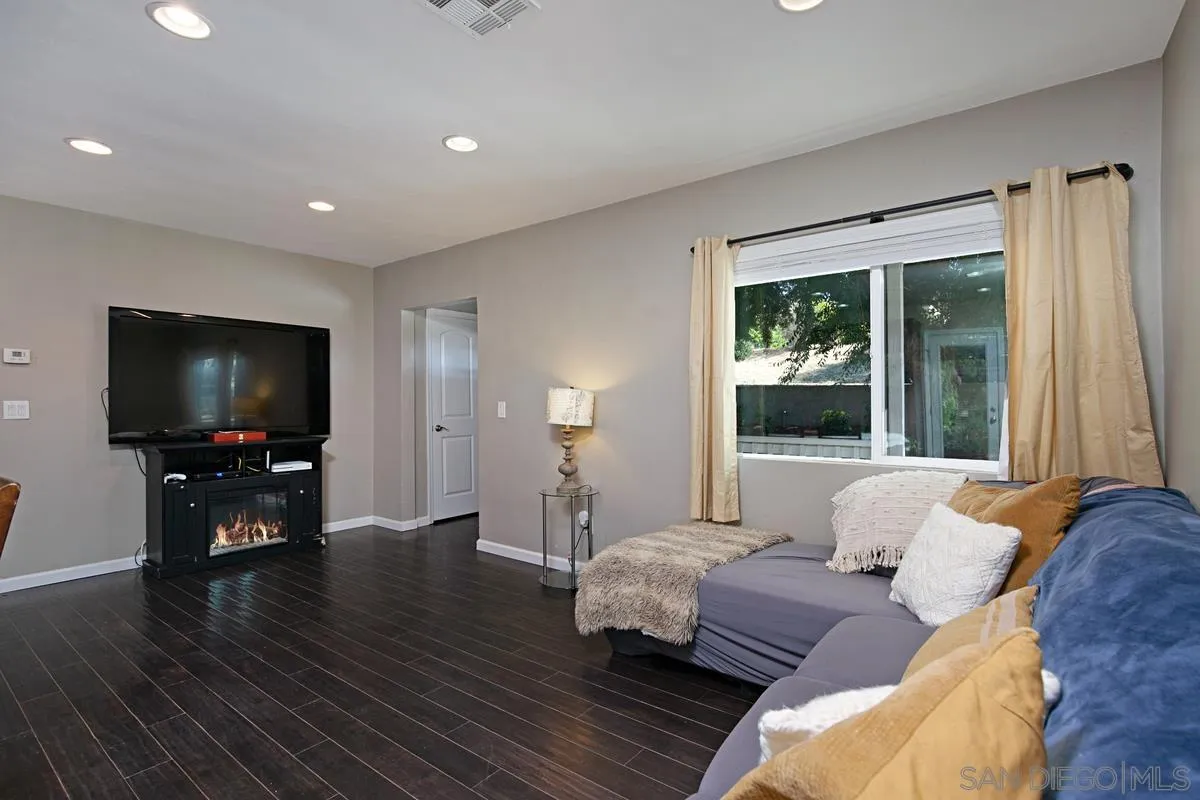 10390 Del Rio Road Spring Valley, CA 91978 - Photo 6 of 38 a living room with furniture and a flat screen tv