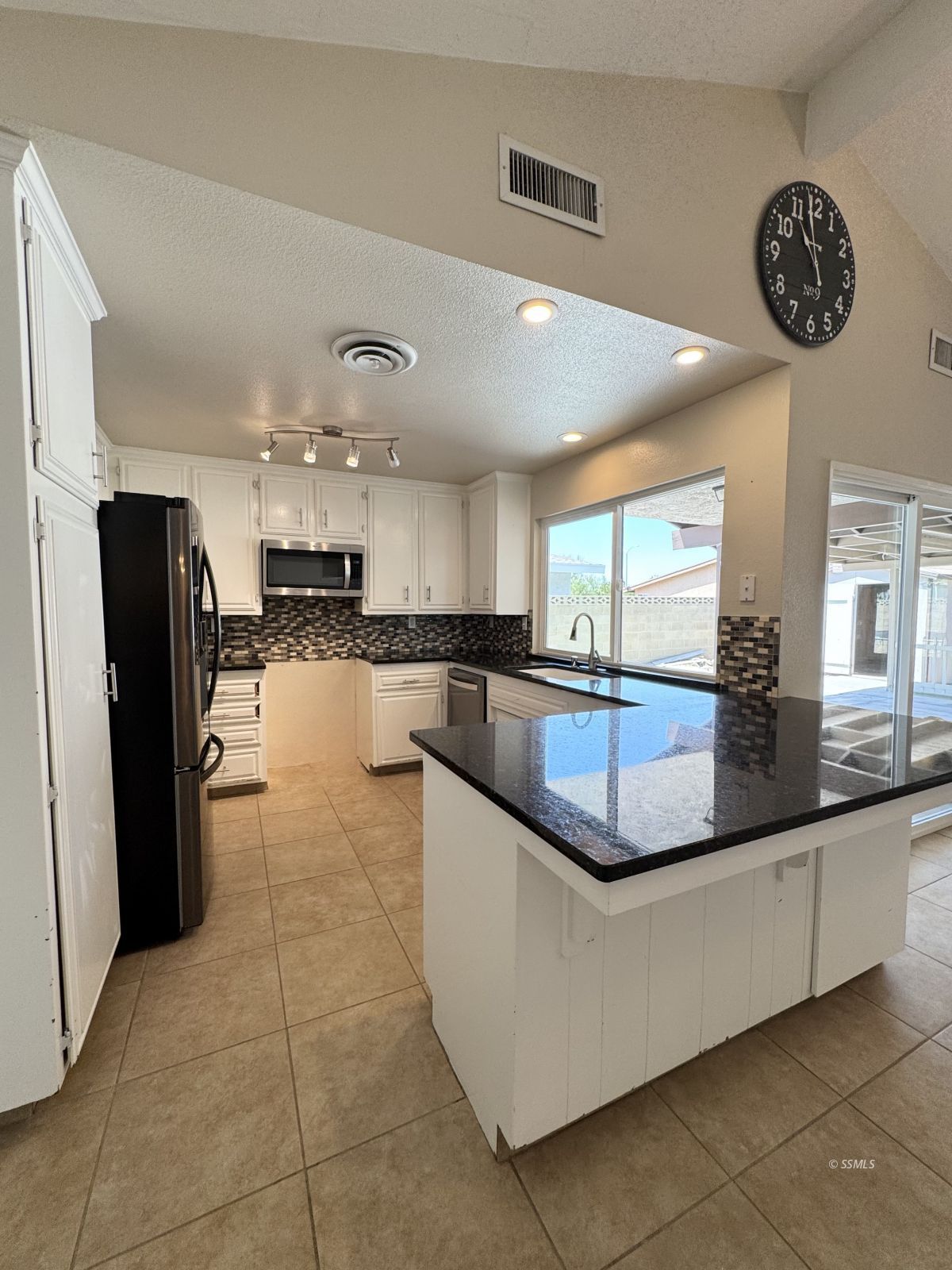 905 North Sierra View Street Ridgecrest, CA 93555 - Photo 12 of 30 a large kitchen with a large counter top and stainless steel appliances