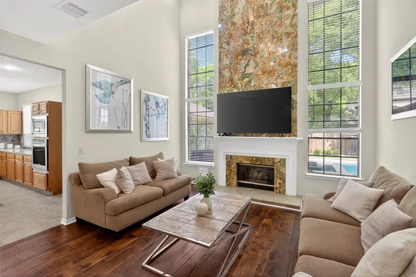 a living room with furniture a fireplace and a flat screen tv