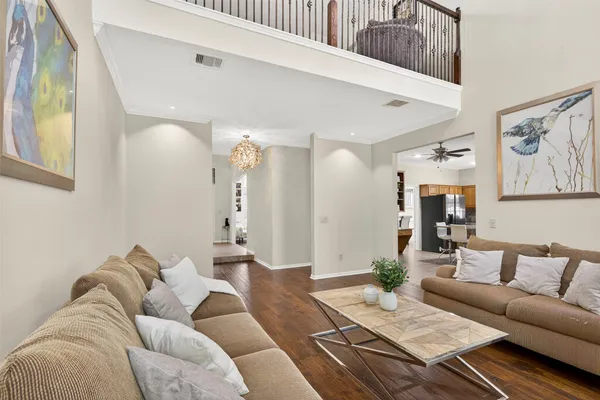 a living room with furniture and wooden floor