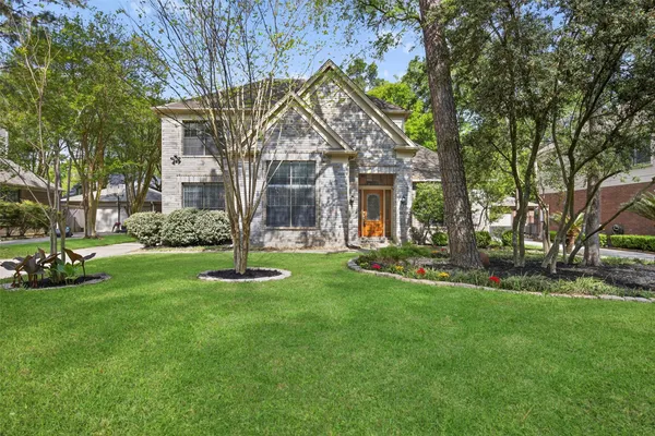 a front view of house with yard and green space