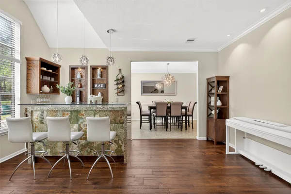a view of a dining room with furniture and wooden floor