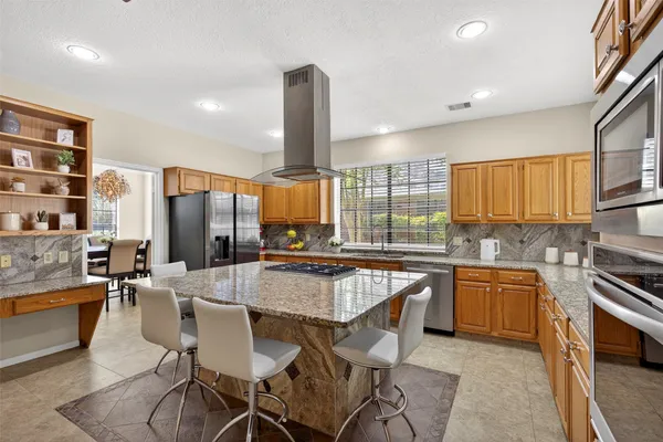 a kitchen with lots of counter top space and appliances