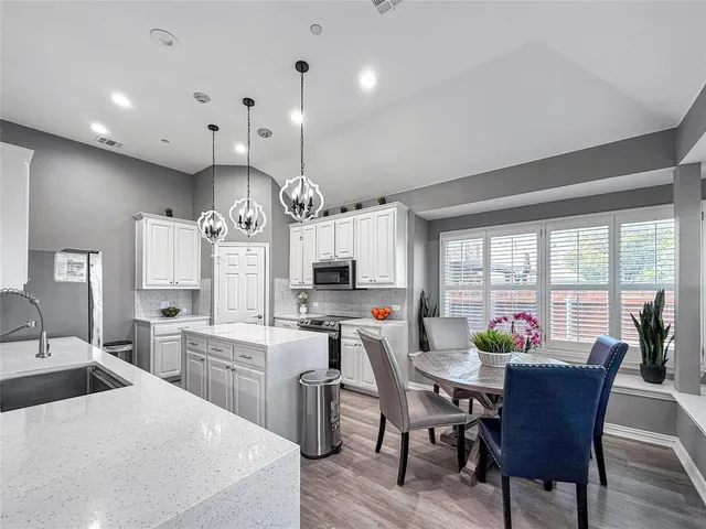 a view of a dining room with furniture and a window
