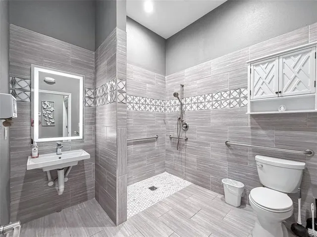 a bathroom with a toilet sink and shower