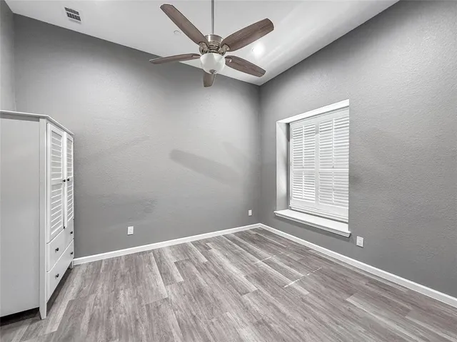 an empty room with windows and closet