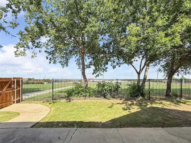 a view of backyard with swimming pool and outdoor seating