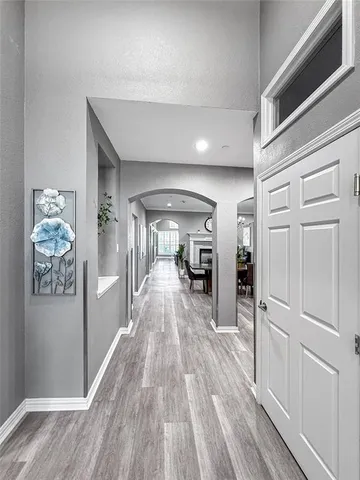 a view of a hallway view with wooden floor and furniture