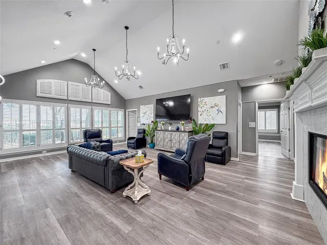 a living room with furniture fireplace and flat screen tv