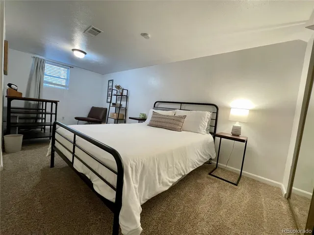 a bedroom with double bed and dresser