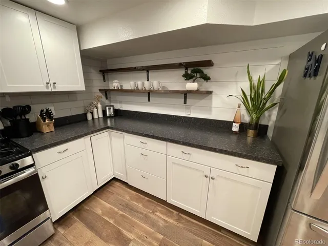 a kitchen with stainless steel appliances a sink and cabinets