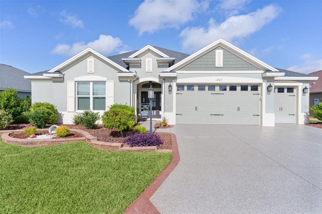 1803 Zientara Loop The Villages, FL 34762 - Photo 1 of 1 a front view of a house with a yard and potted plants