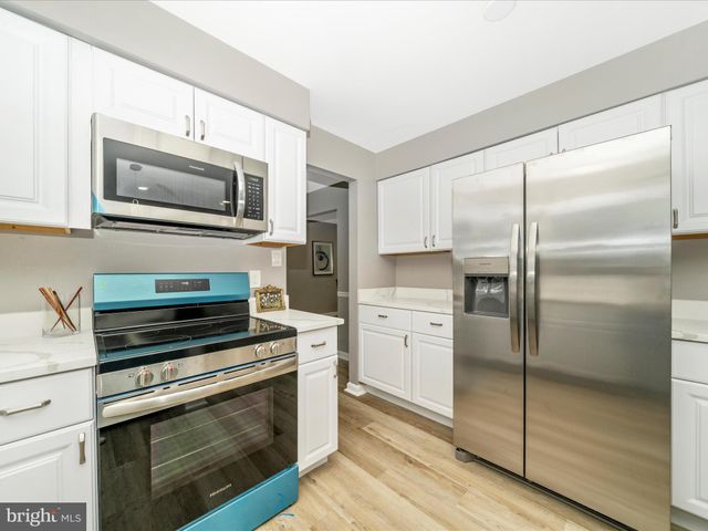 a view of a livingroom with wooden floor and a flat screen tv