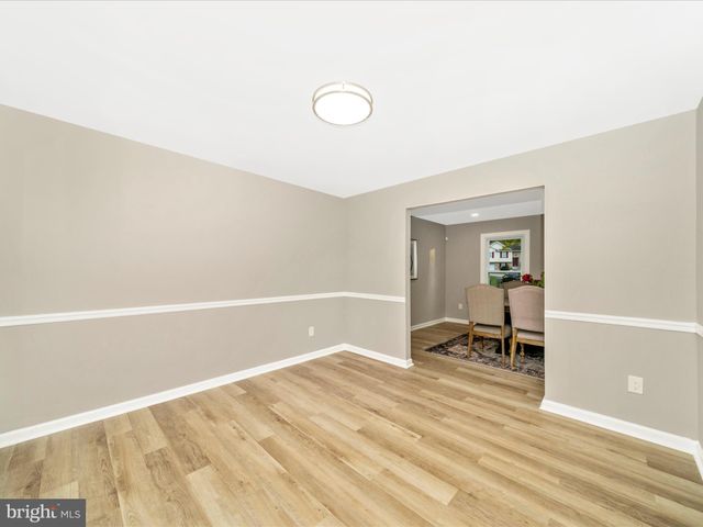 a kitchen with kitchen island white cabinets and refrigerator