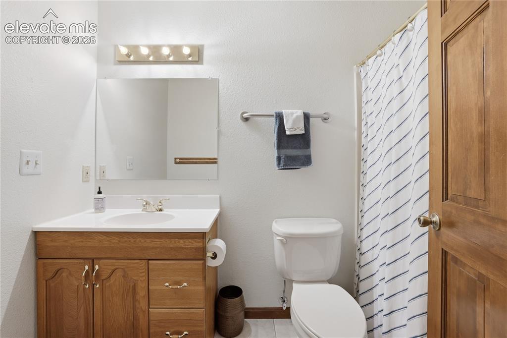 18190 Forest View Road Monument, CO 80132 - Photo 31 of 50 a bathroom with a sink a toilet and mirror