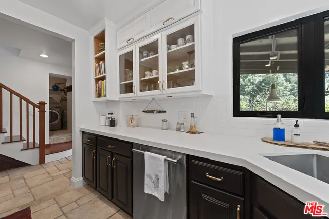 a kitchen with stainless steel appliances a sink stove and cabinets