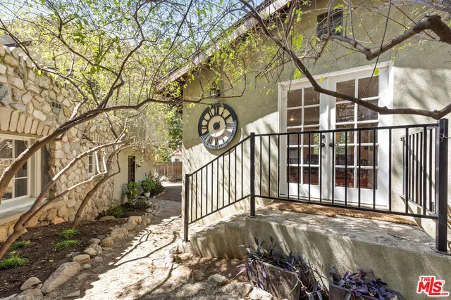 a view of a brick house with a small yard