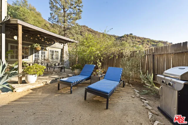 a view of a chairs setting in the backyard of a house