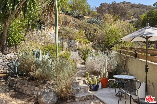 a view of a porch with furniture and a yard