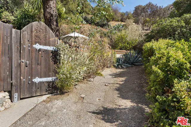a view of a house with a yard and pathway